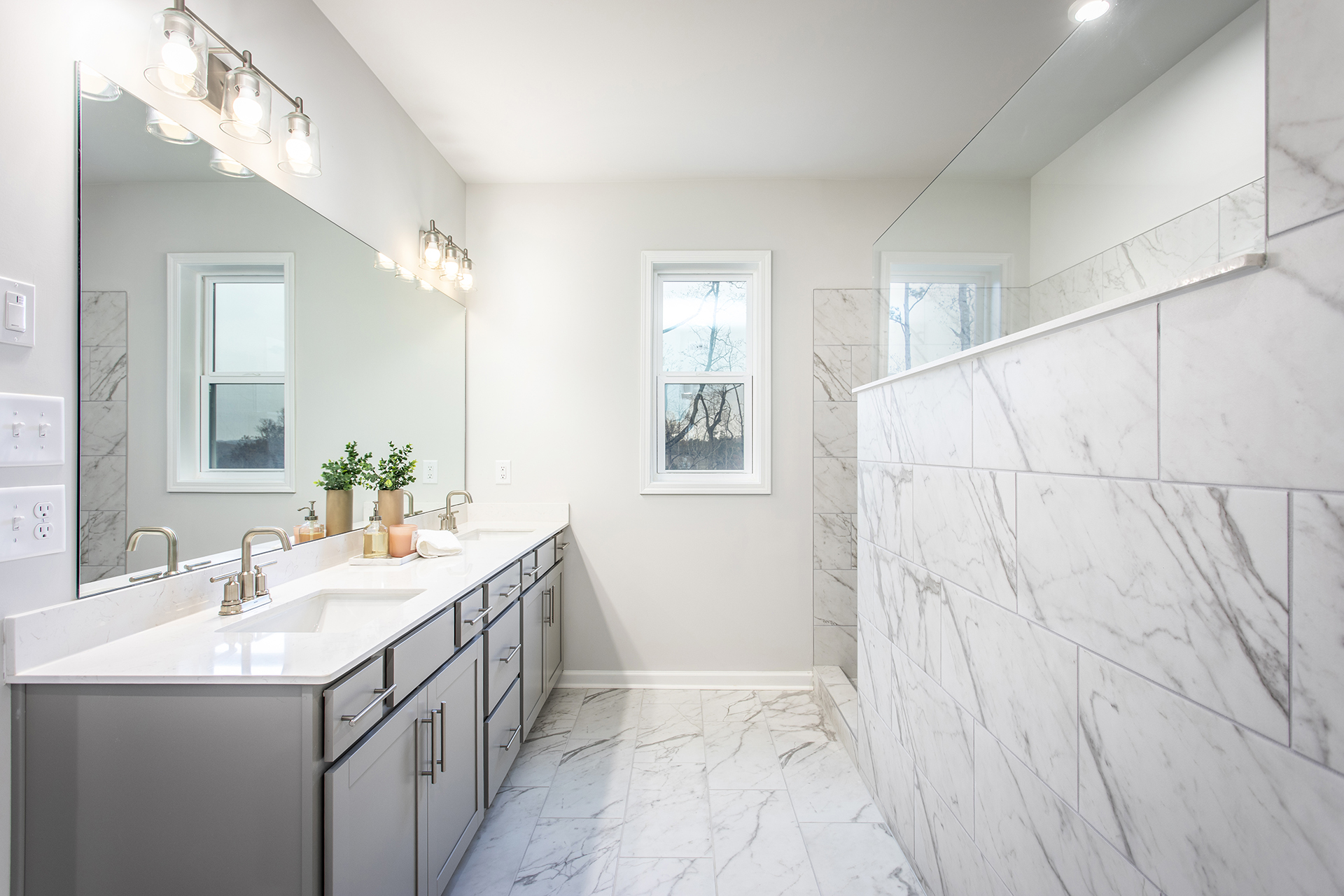 primary bathroom with gray cabinets and tile flooring