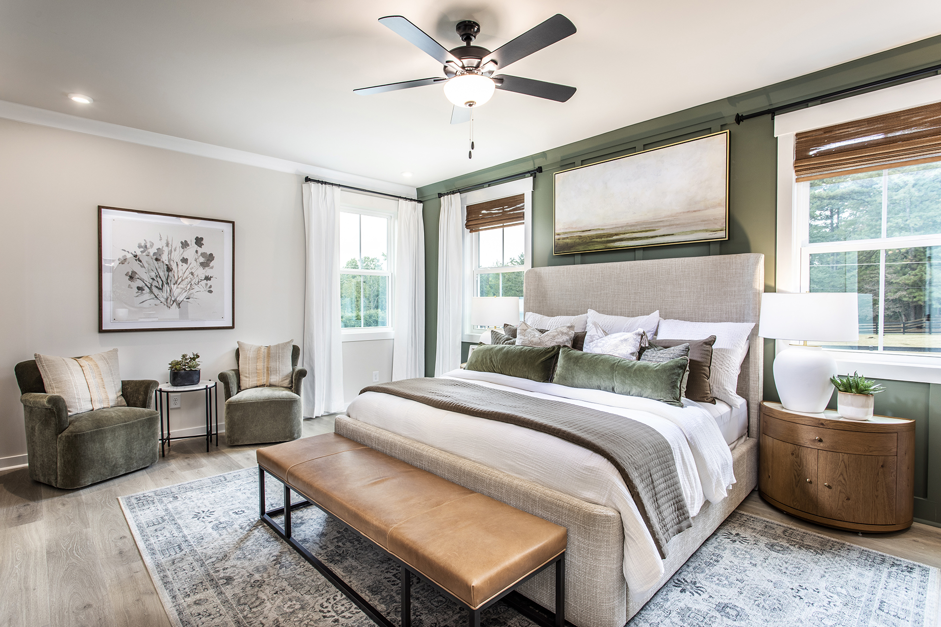 primary bedroom with king bed and plank flooring