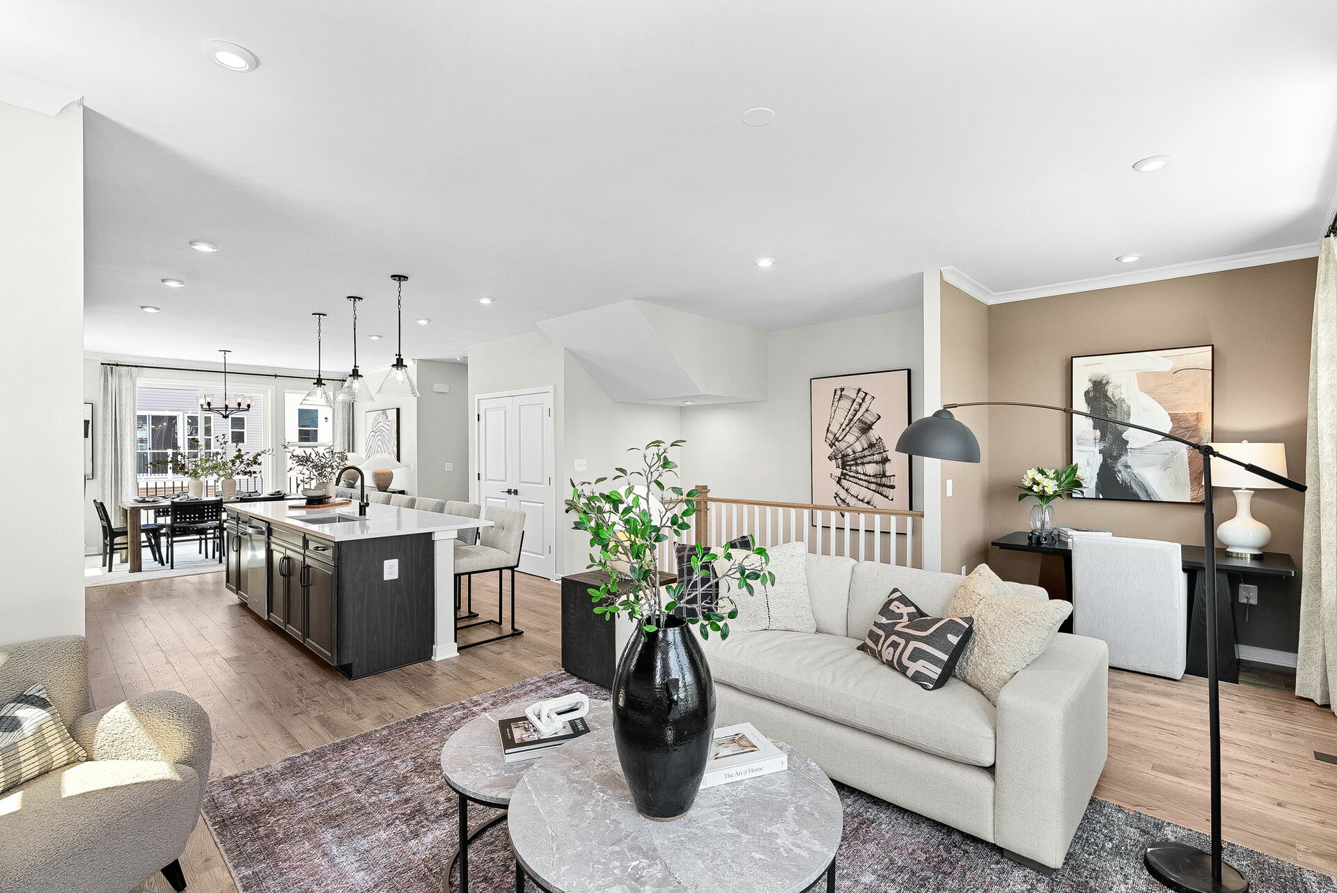 hardwood floors, carpet, sofa and coffee table with view of kitchen and office