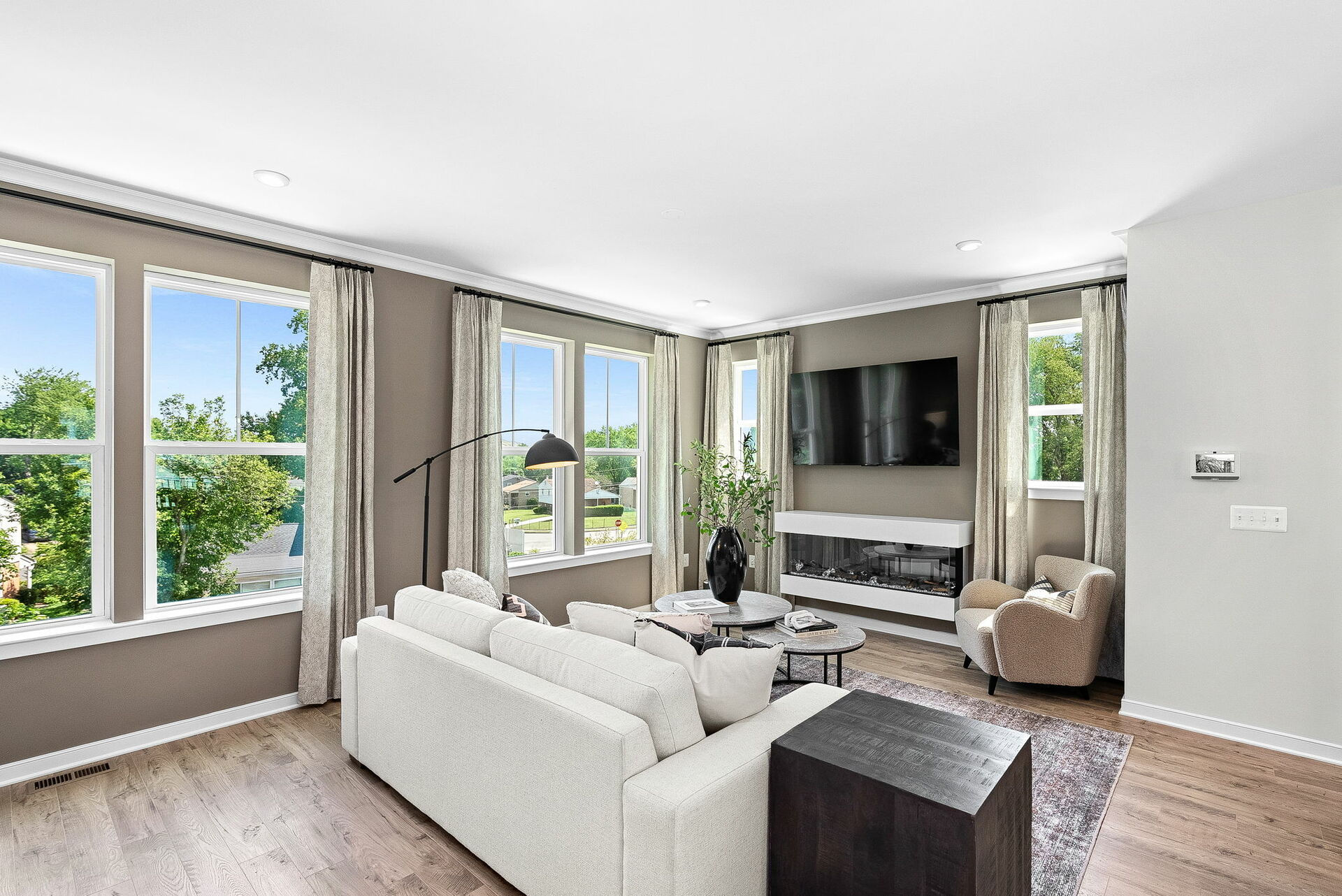 room with carpet and hardwood floors, fireplace, sofa and chairs