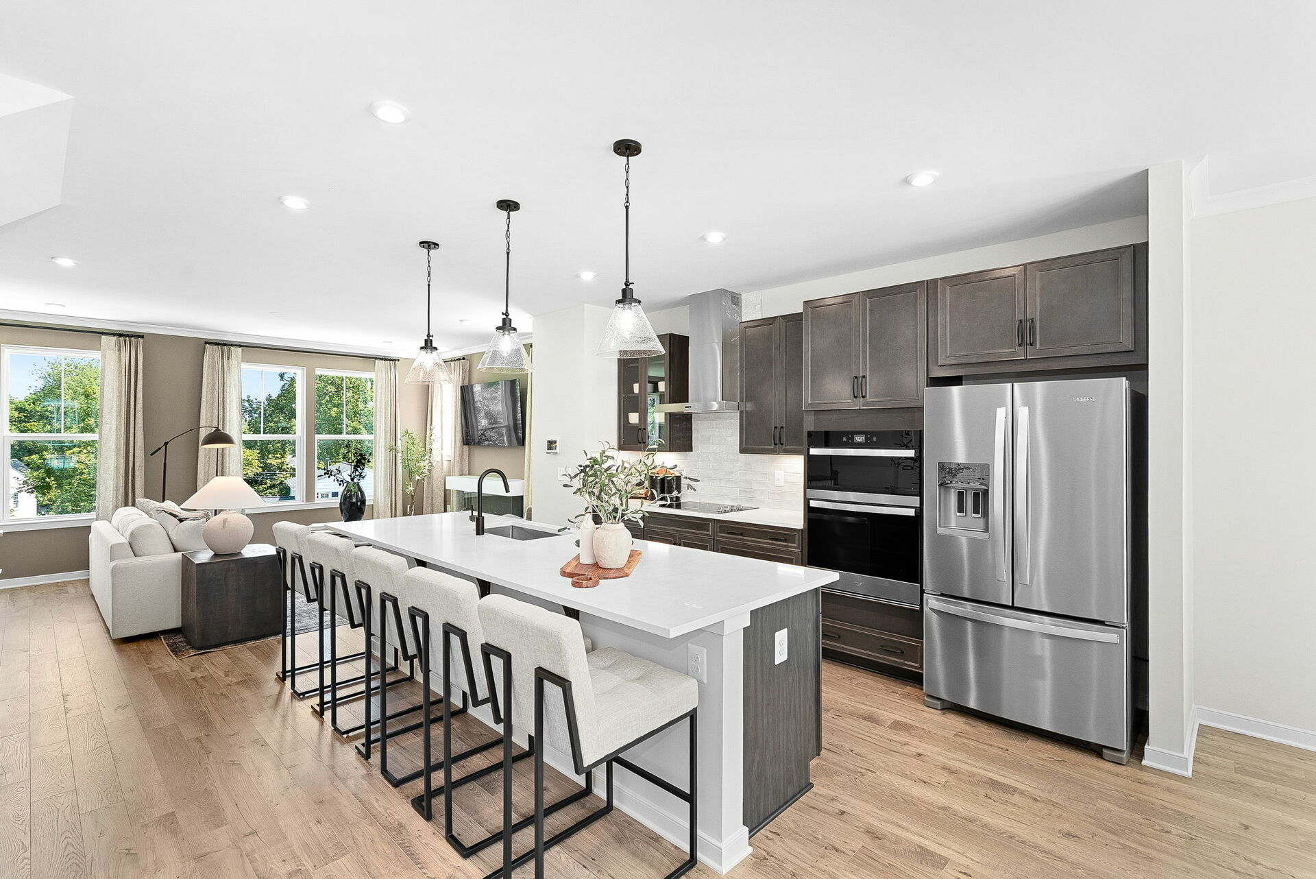white quartz countertops with black hardware & brown cabinets