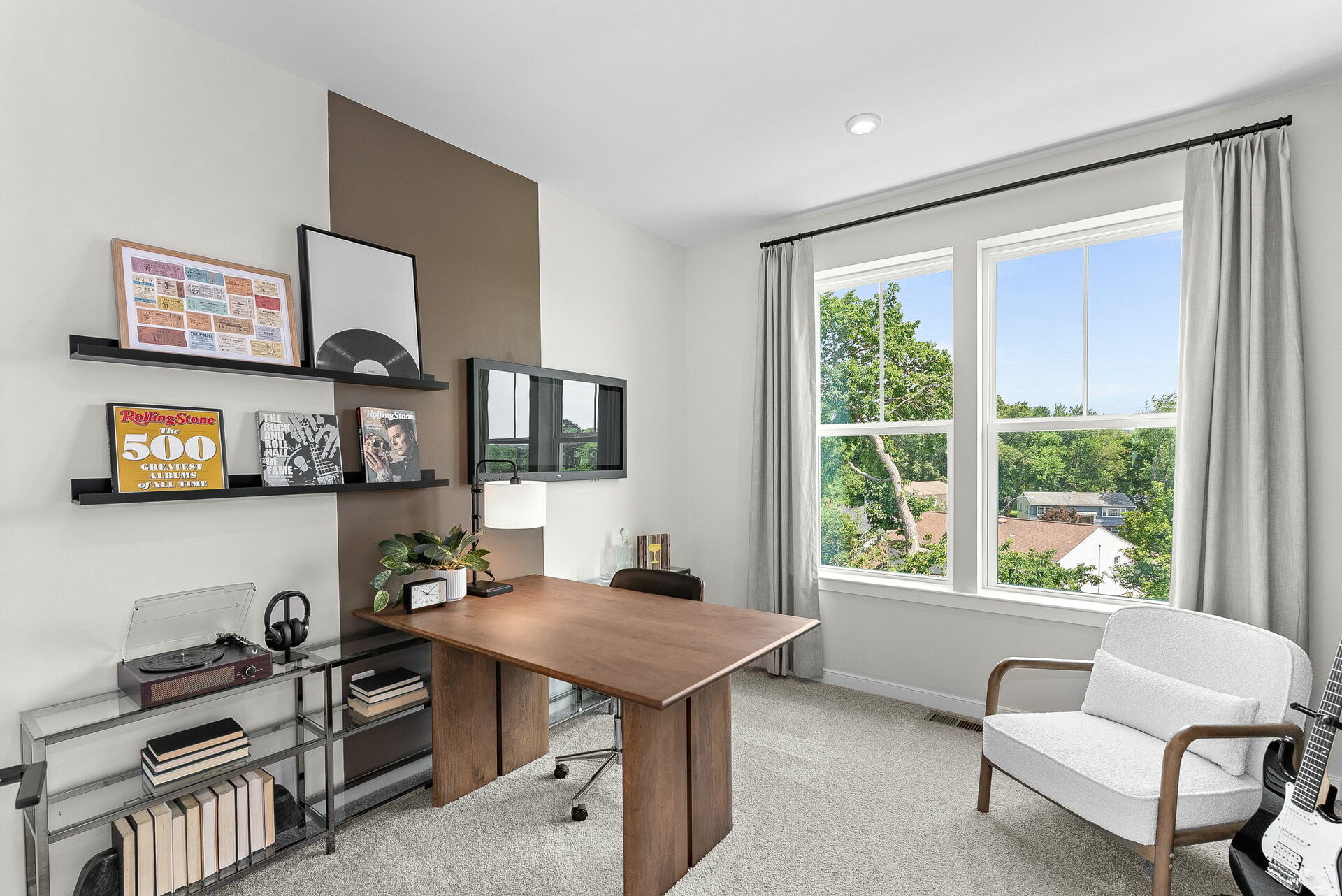 bedroom with desk, shelves, and large white chair