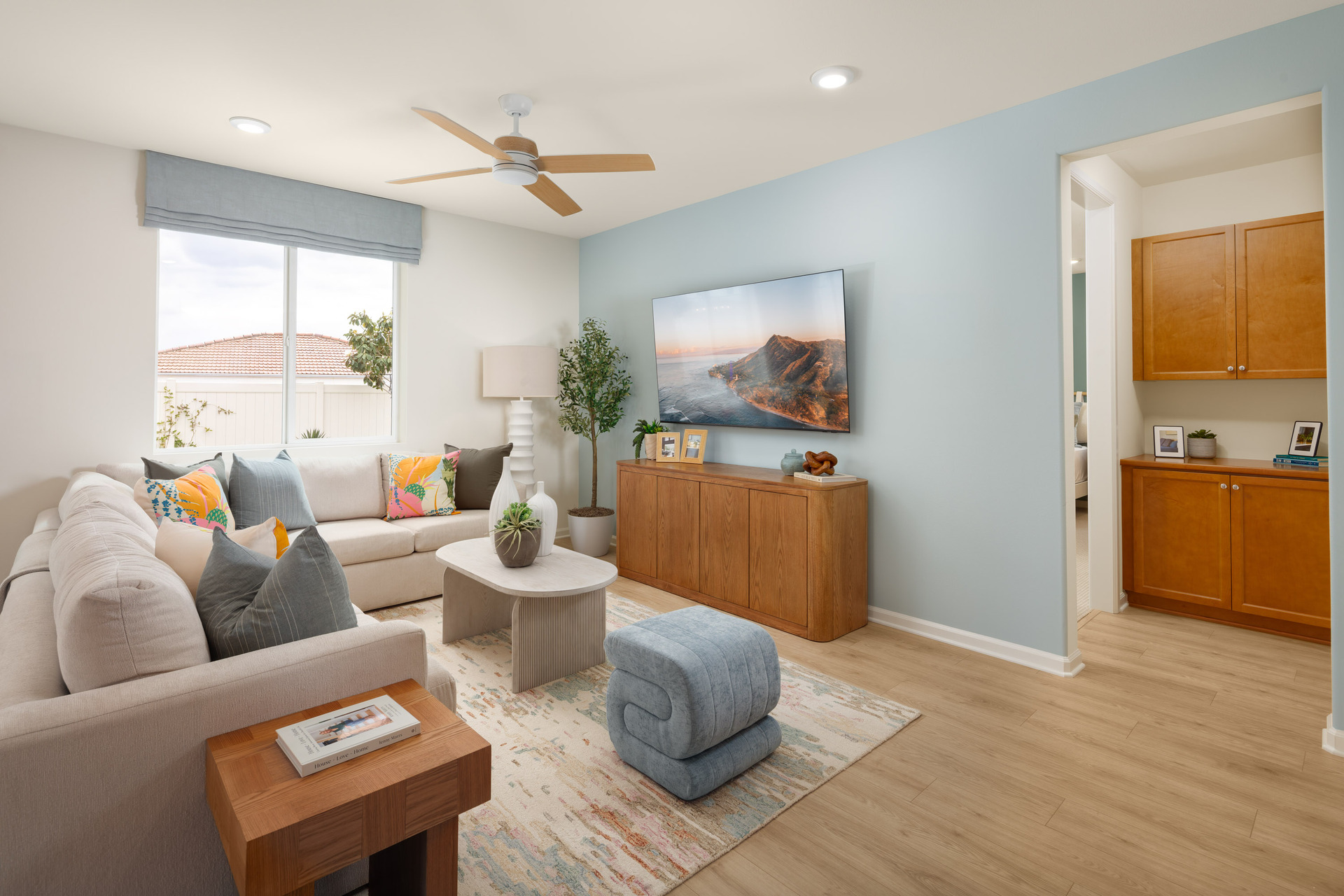 great room with neutral floors and large windows