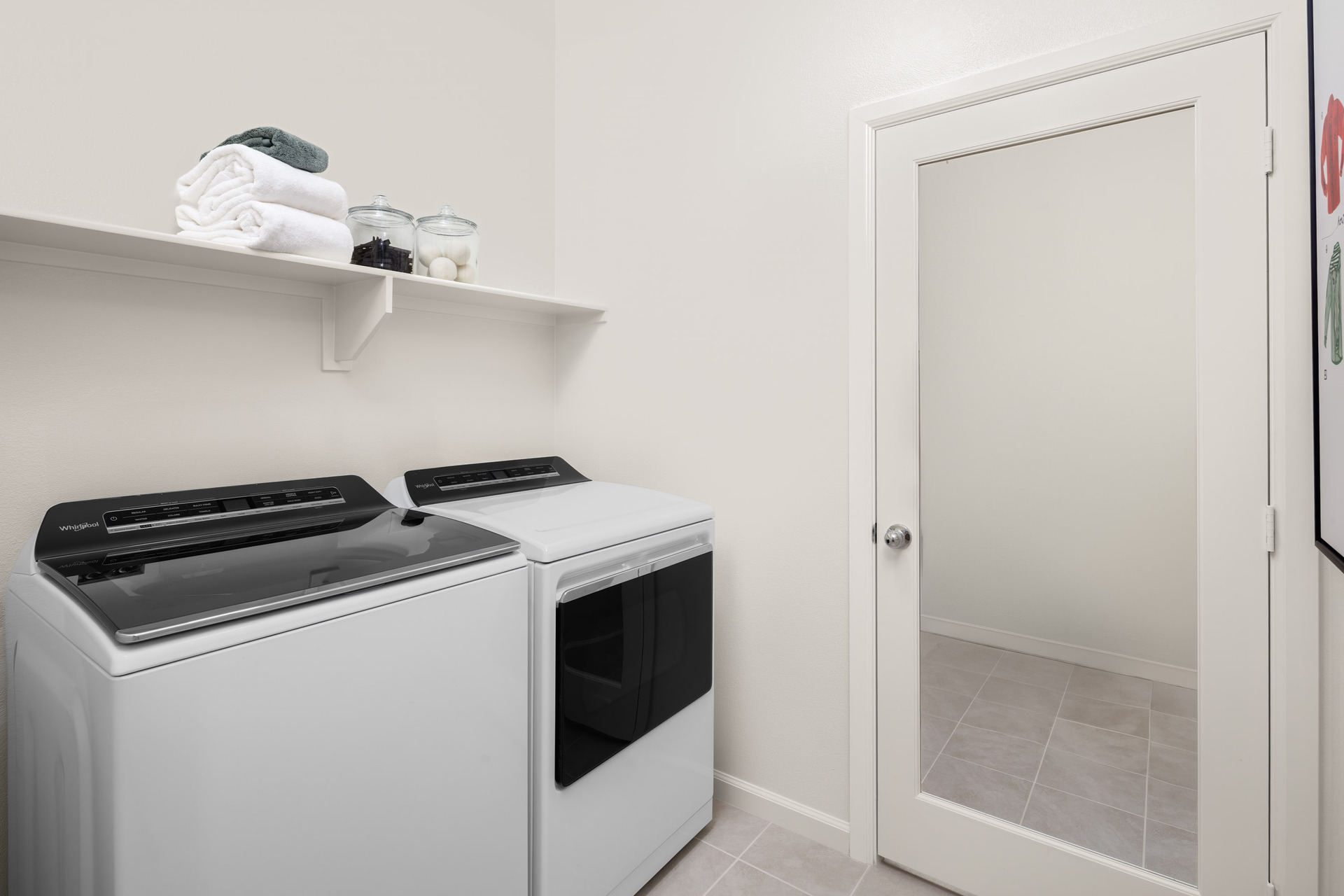 laundry room with neutral floors and shelves