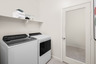 laundry room with neutral floors and shelves