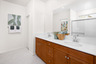 primary bathroom with neutral floors and white countertops