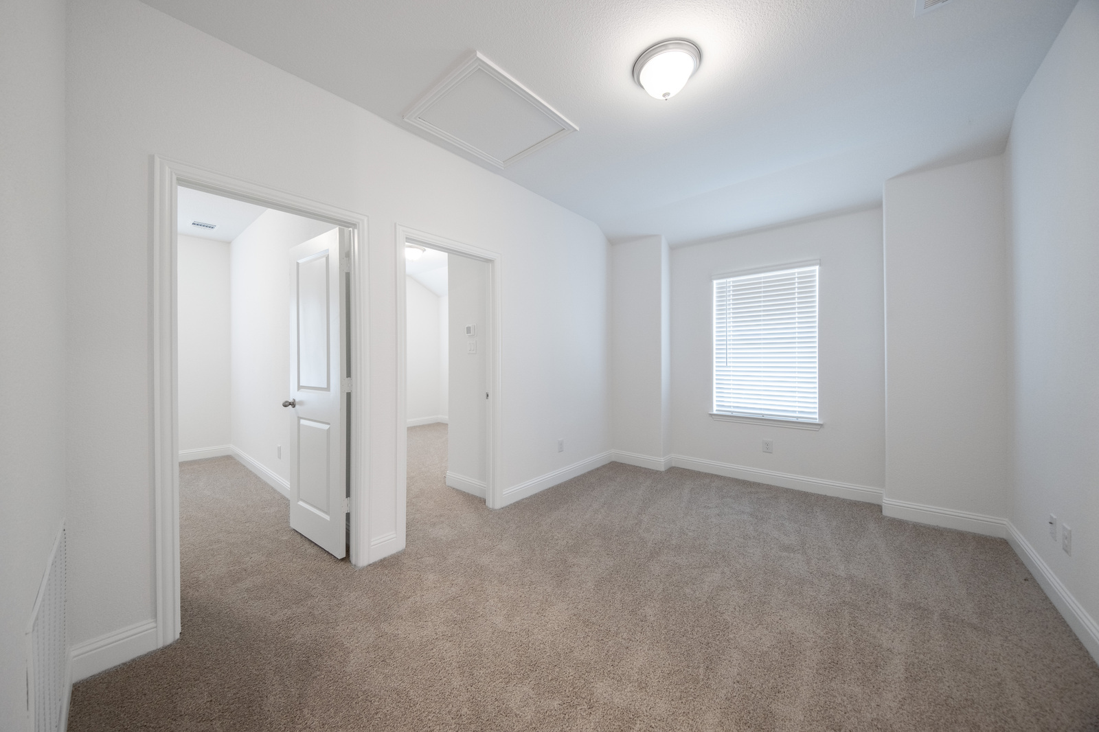 upstairs loft with carpet and window