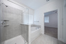 primary bathroom with walk-in shower and soaking tub
