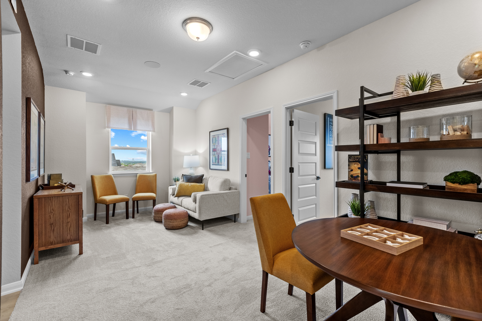loft with carpet, couches & a table with games