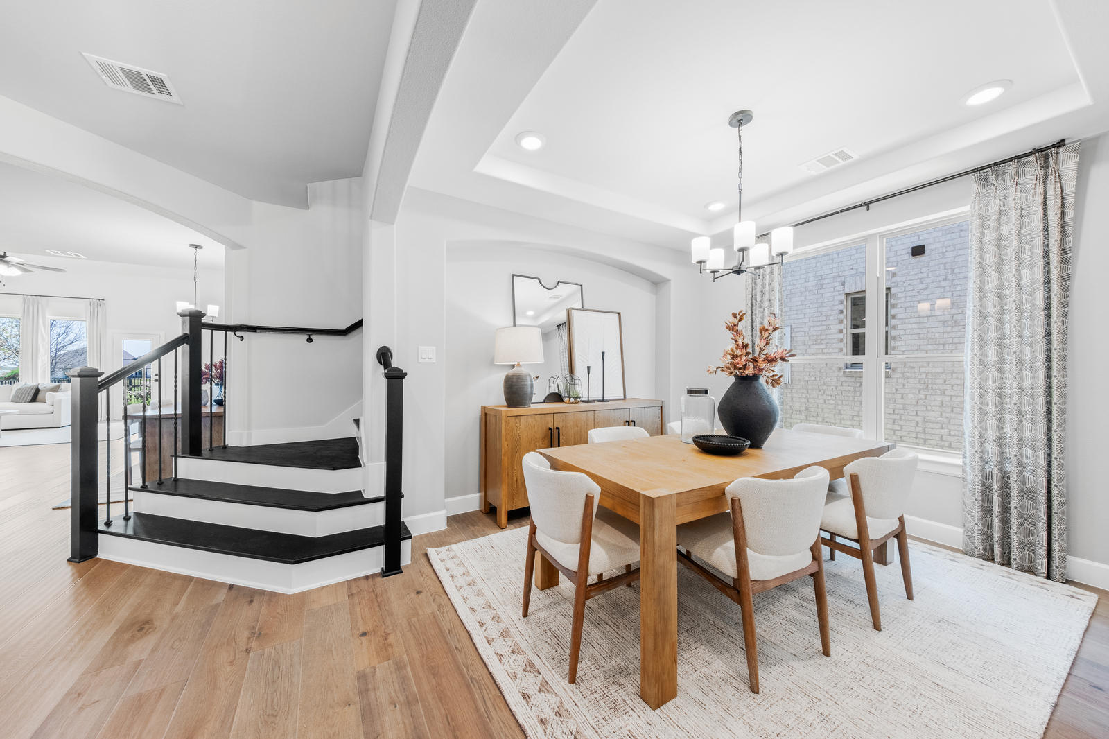 spacious dining room with hardwood flooring and windows