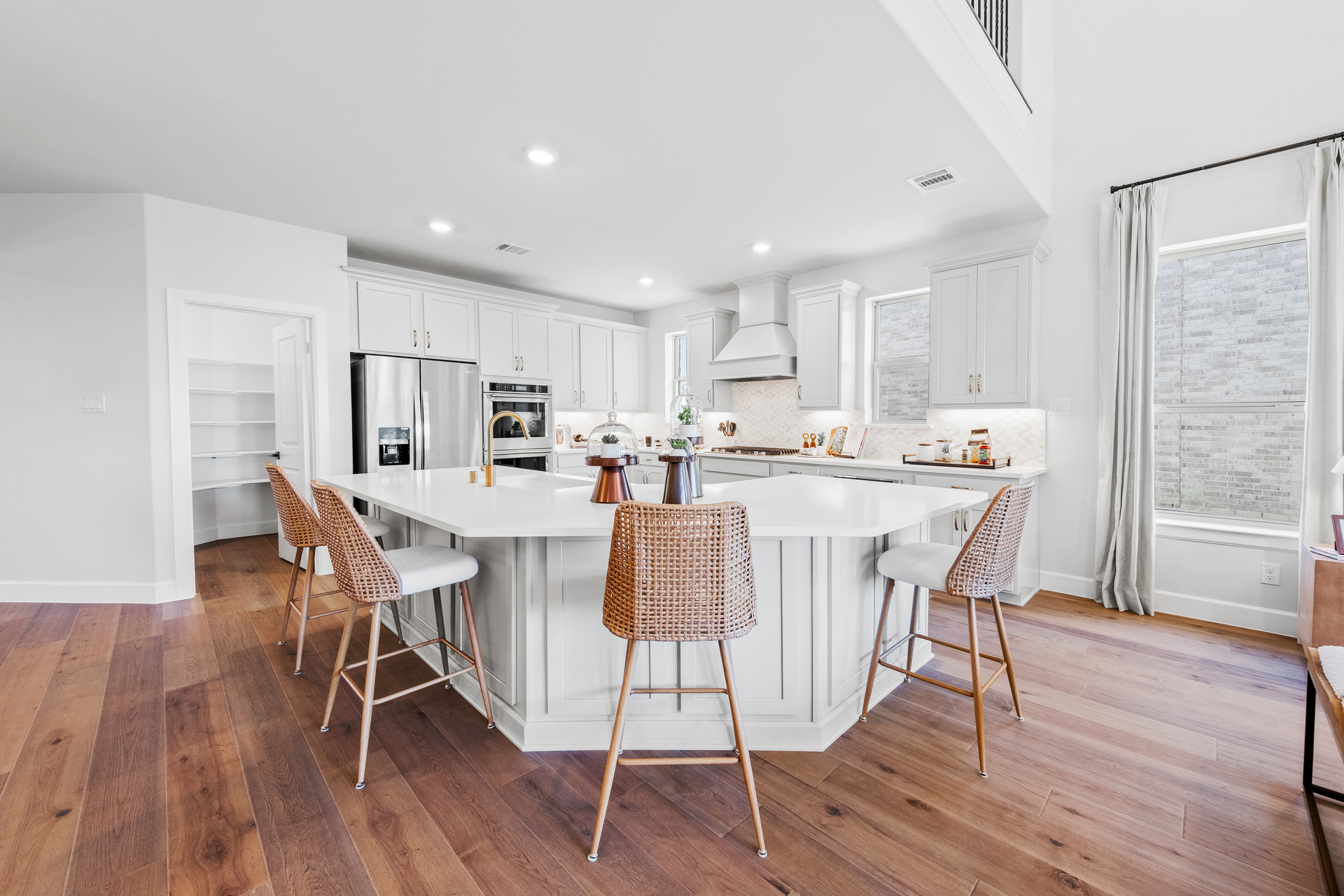 spacious kitchen with oversized island and hardwood flooring