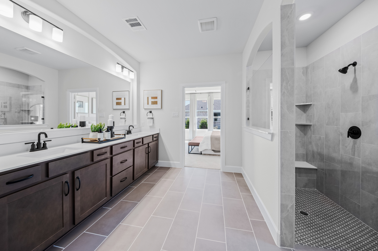 spacious primary bathroom with large walk-in shower