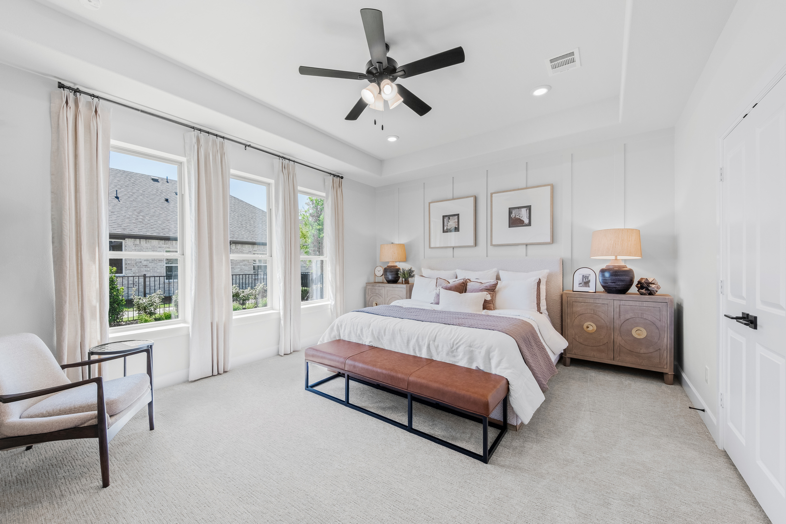 primary bedroom with carpet and windows