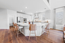 spacious kitchen with oversized island and hardwood flooring