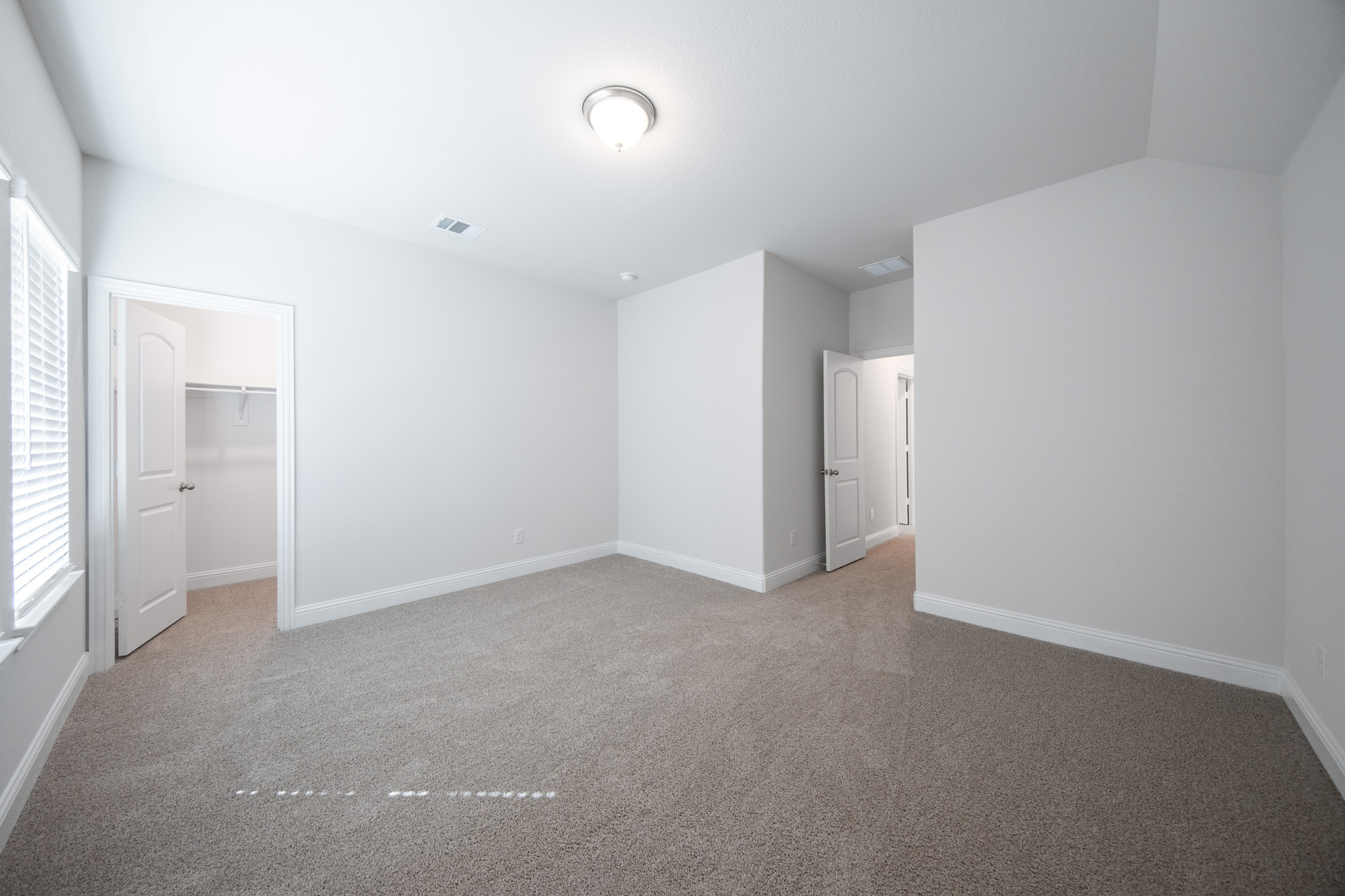 guest bedroom with carpet and walk-in closet