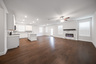 open great room with electric fireplace and hardwood flooring