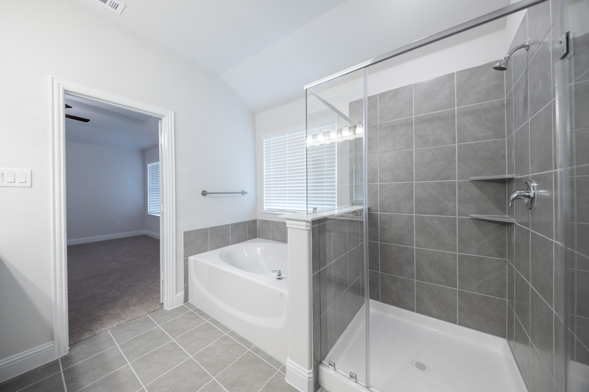 primary bathroom with walk-in closet and soaking tub