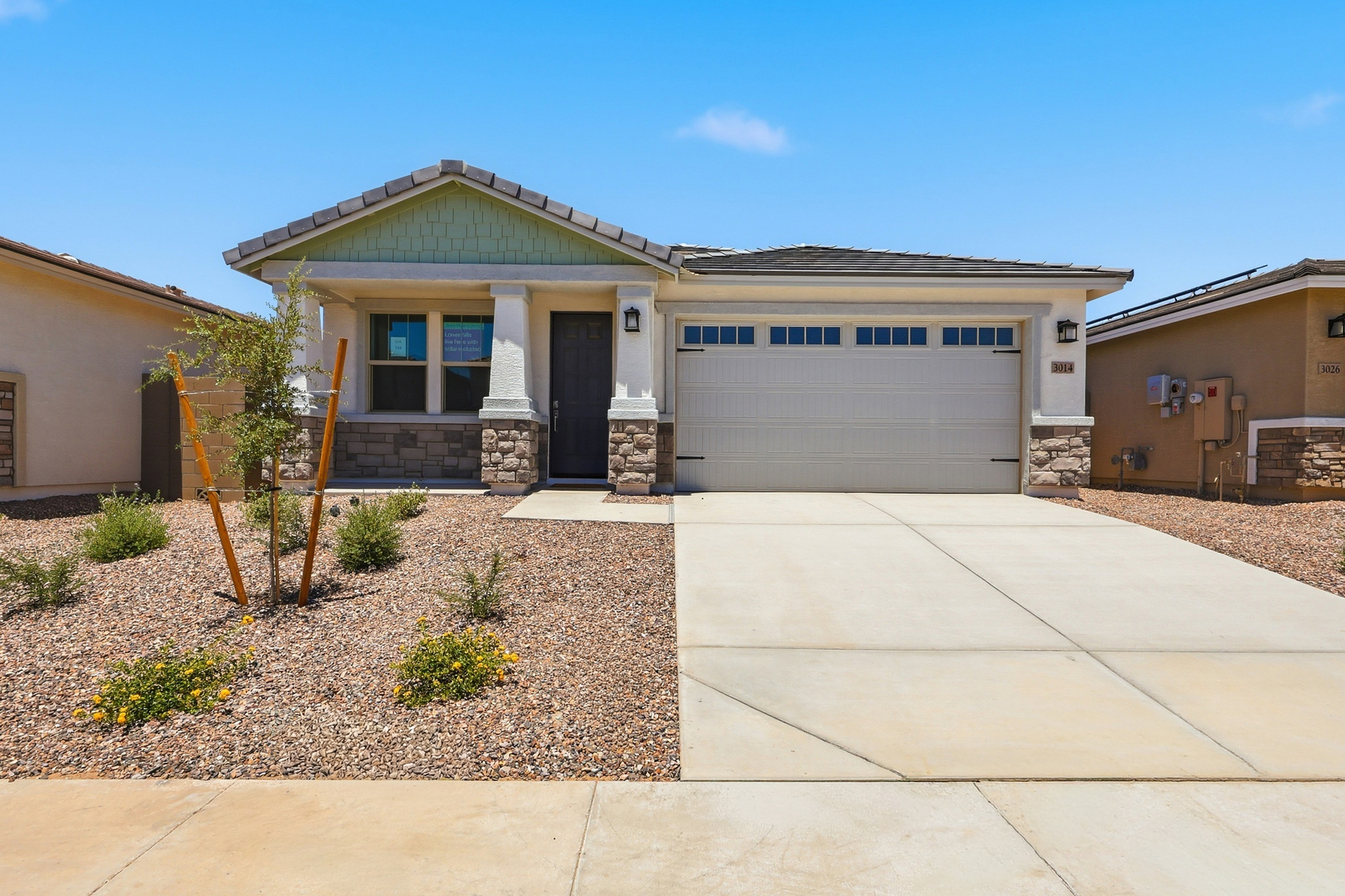 single-story single-family home with desert landscaping and a concrete driveway