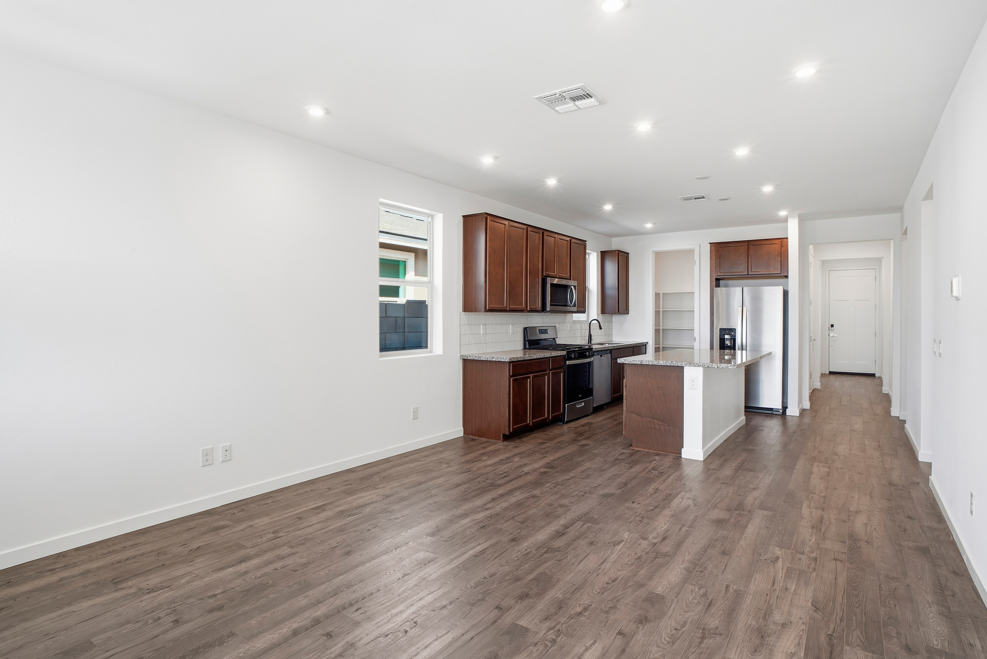 open-concept space with wood-like flooring and plenty of natural light