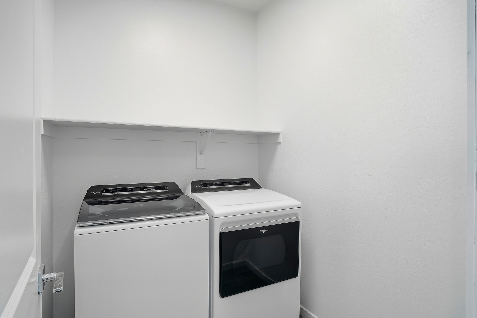 spacious laundry room with whirlpool washer and dryer