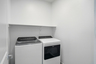 spacious laundry room with whirlpool washer and dryer