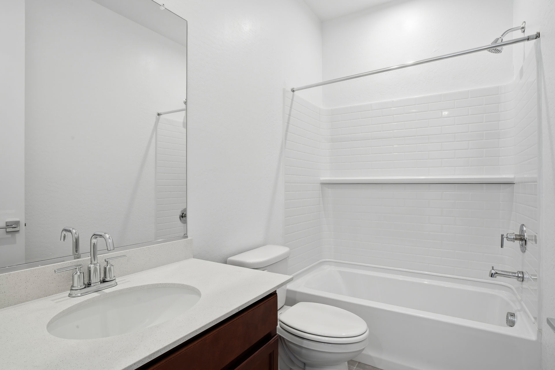 bathroom with brown cabinets and chrome faucet
