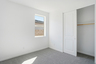 bedroom with light grey carpet and closet with sliding door