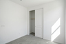 bedroom with light grey carpet and closet with sliding door
