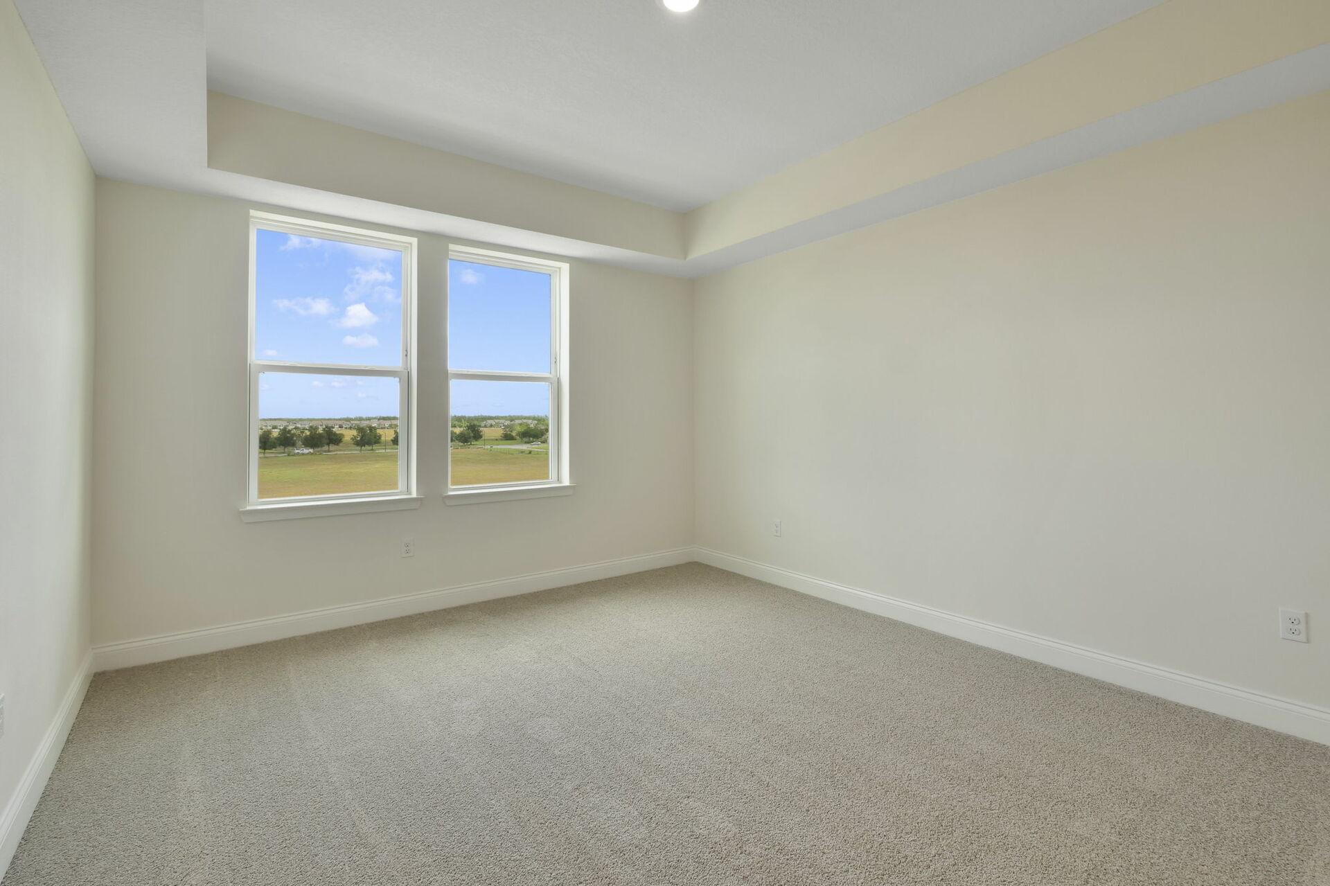 carpet throughout, tray ceiling with dual windows