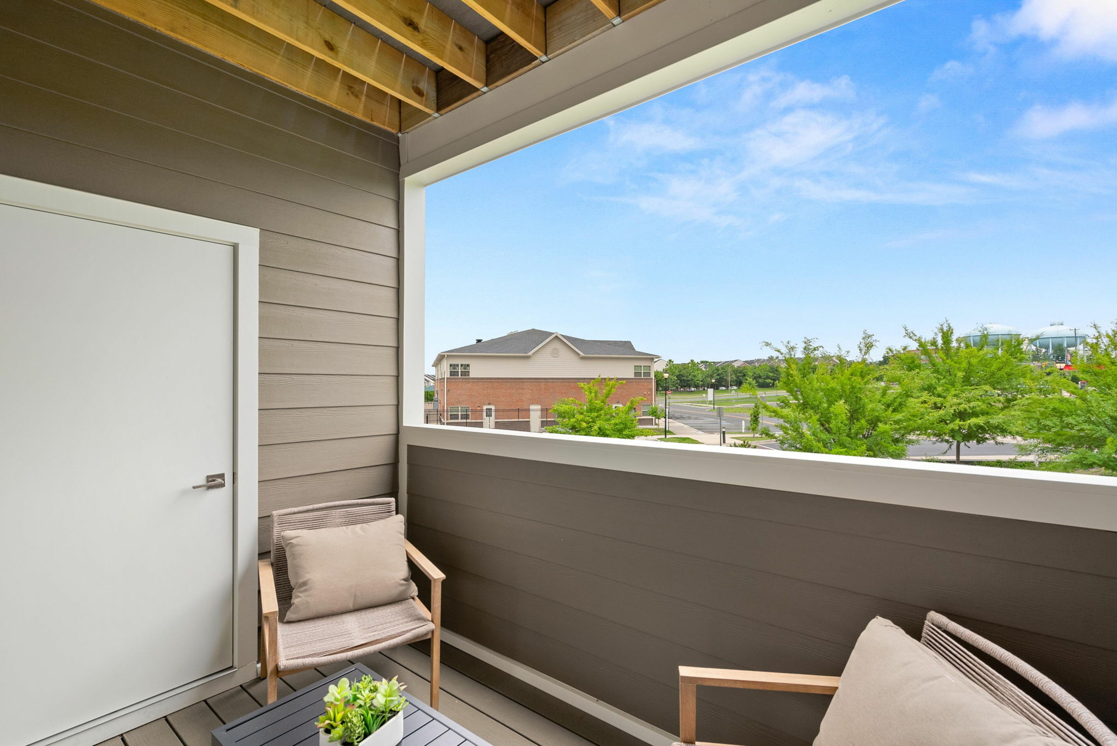 covered terrace with 2 chairs and view of neighborhood