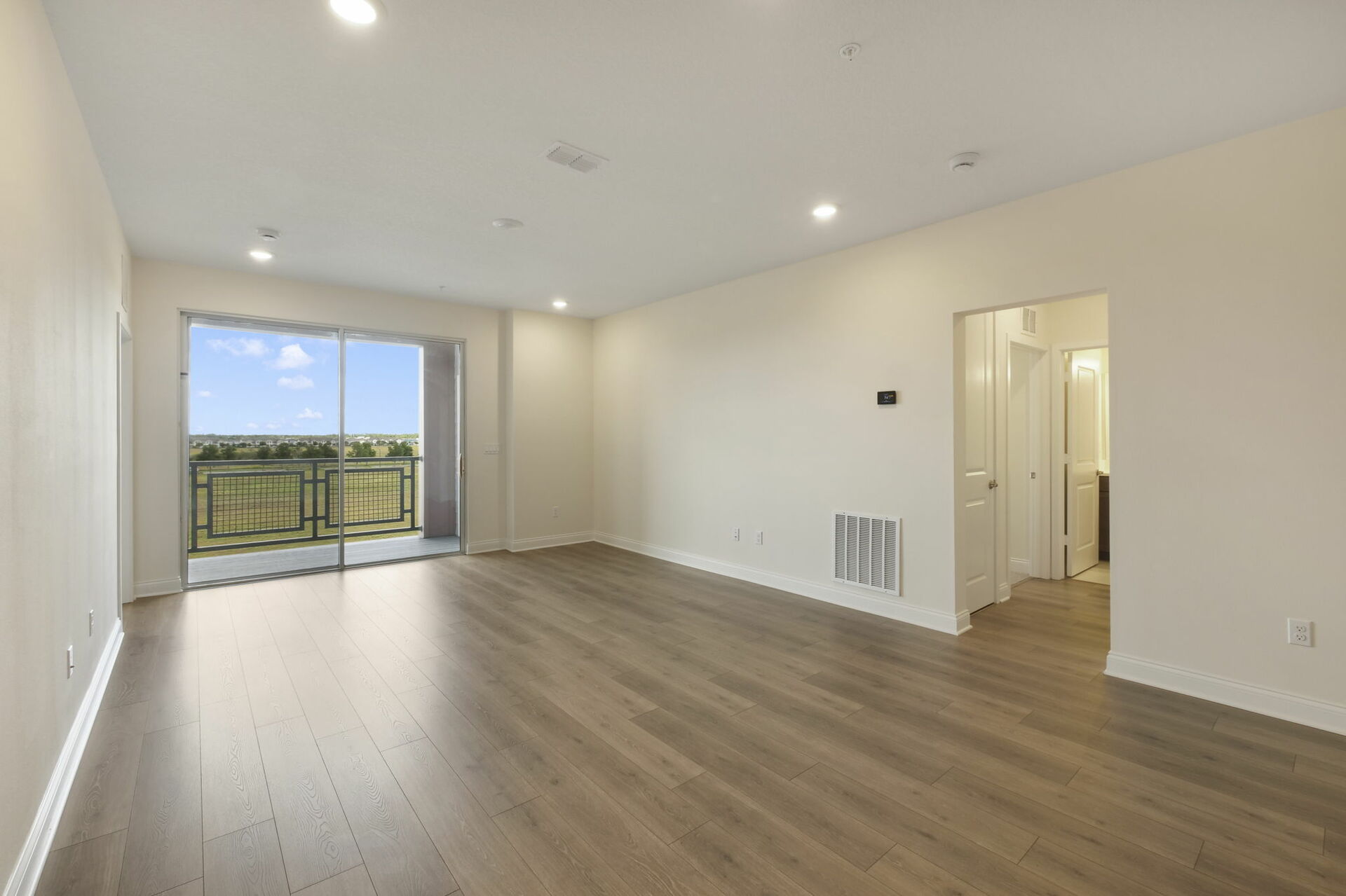room with view of the kitchen and access to the cover patio