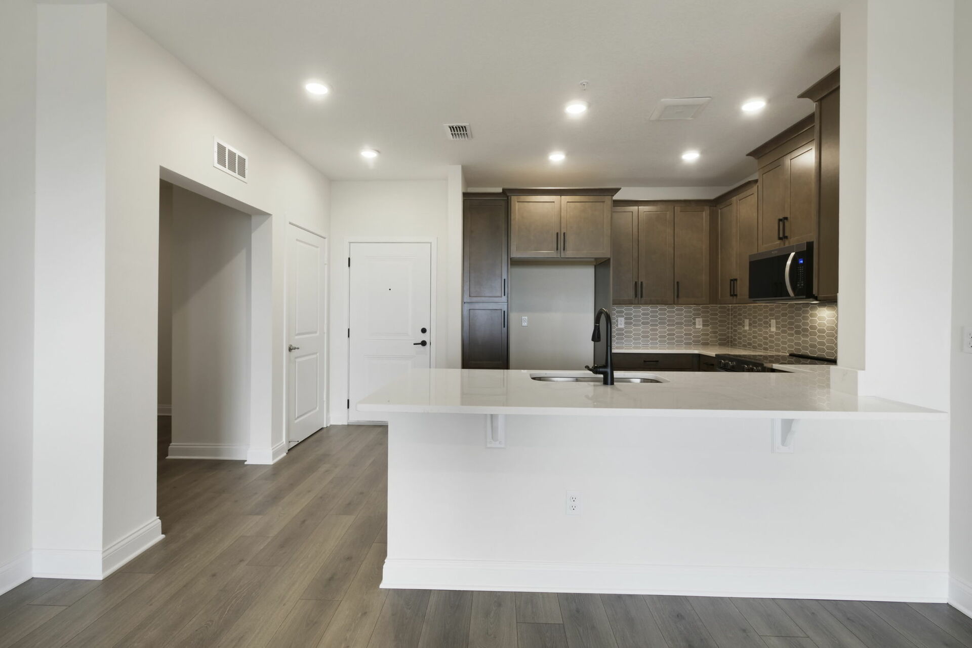 stainless steel appliances, natural wood cabinetry and deep kitchen sink 