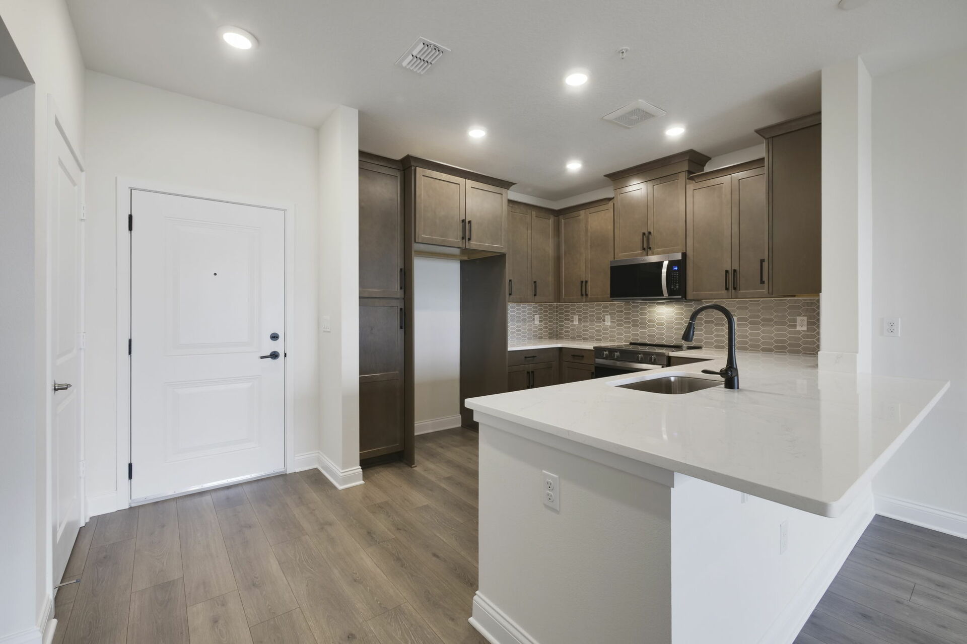 stainless steel appliances, natural wood cabinetry and deep kitchen sink 