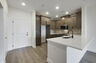 stainless steel appliances, natural wood cabinetry and deep kitchen sink 