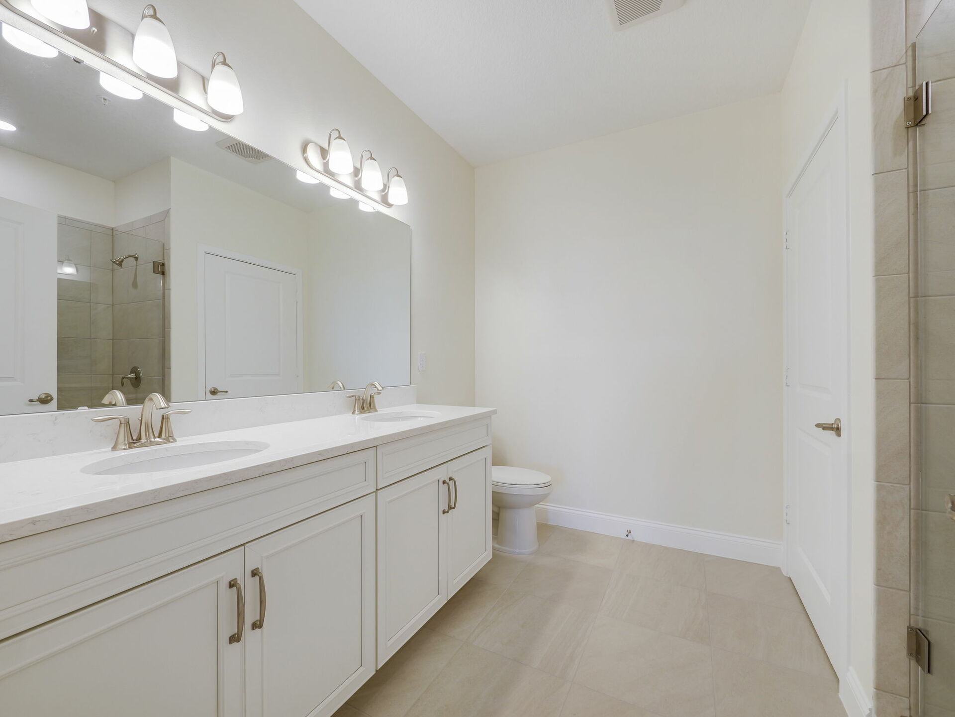 dual sink vanity, closet and shower