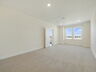 carpet throughout with view of sitting room and access to primary bathroom