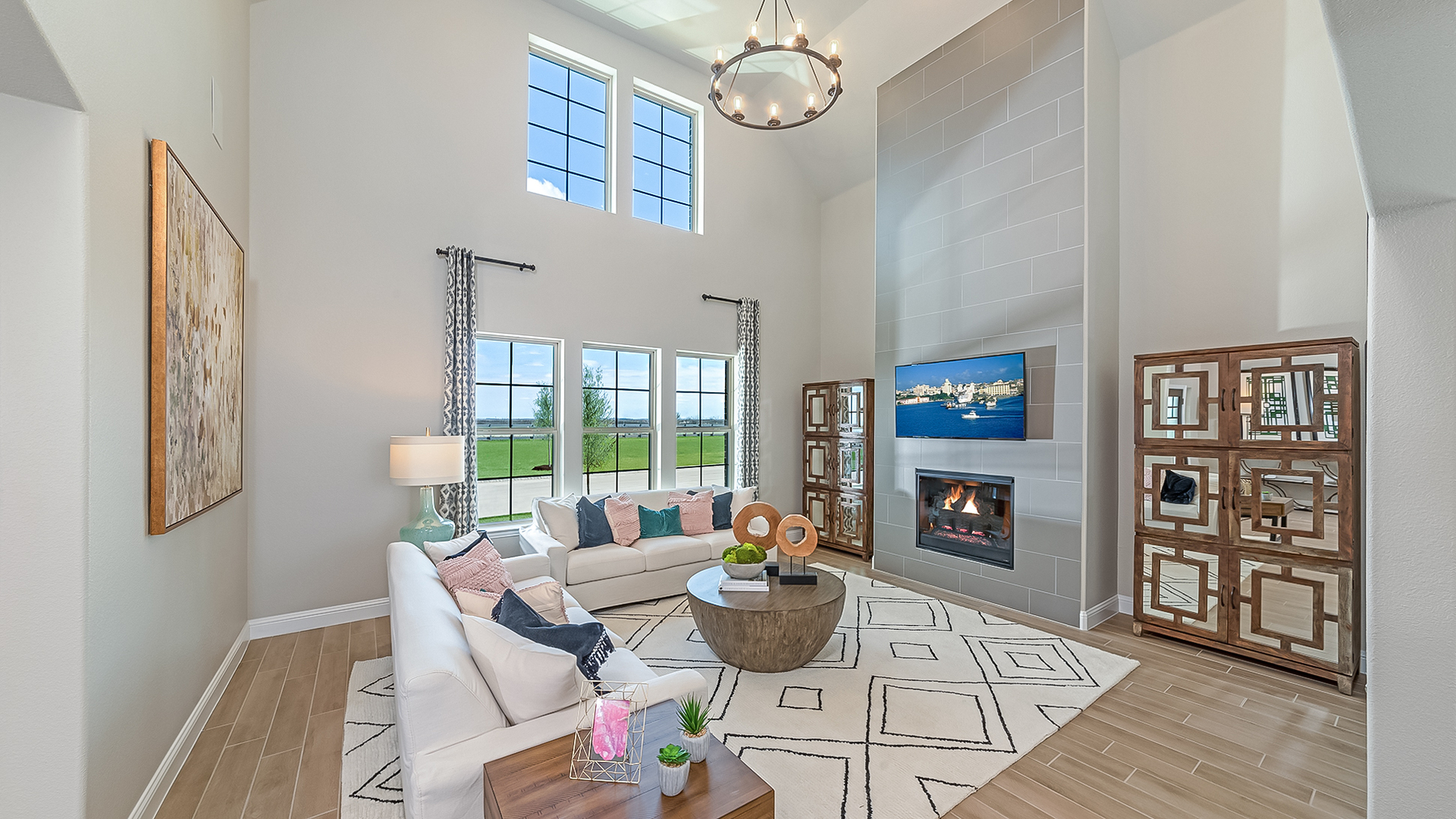 great room with wood flooring, two story ceiling, and fireplace