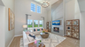 great room with wood flooring, two story ceiling, and fireplace