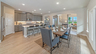 kitchen with gray cabinets, large island, and view of the dining room