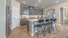 kitchen with gray cabinets, white countertops, and a large island with barstools