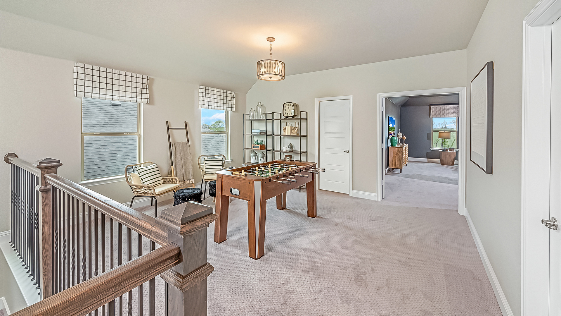 loft space with carpet flooring, white trim, and large windows