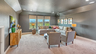 media room with carpet flooring, large windows, and tray ceiling