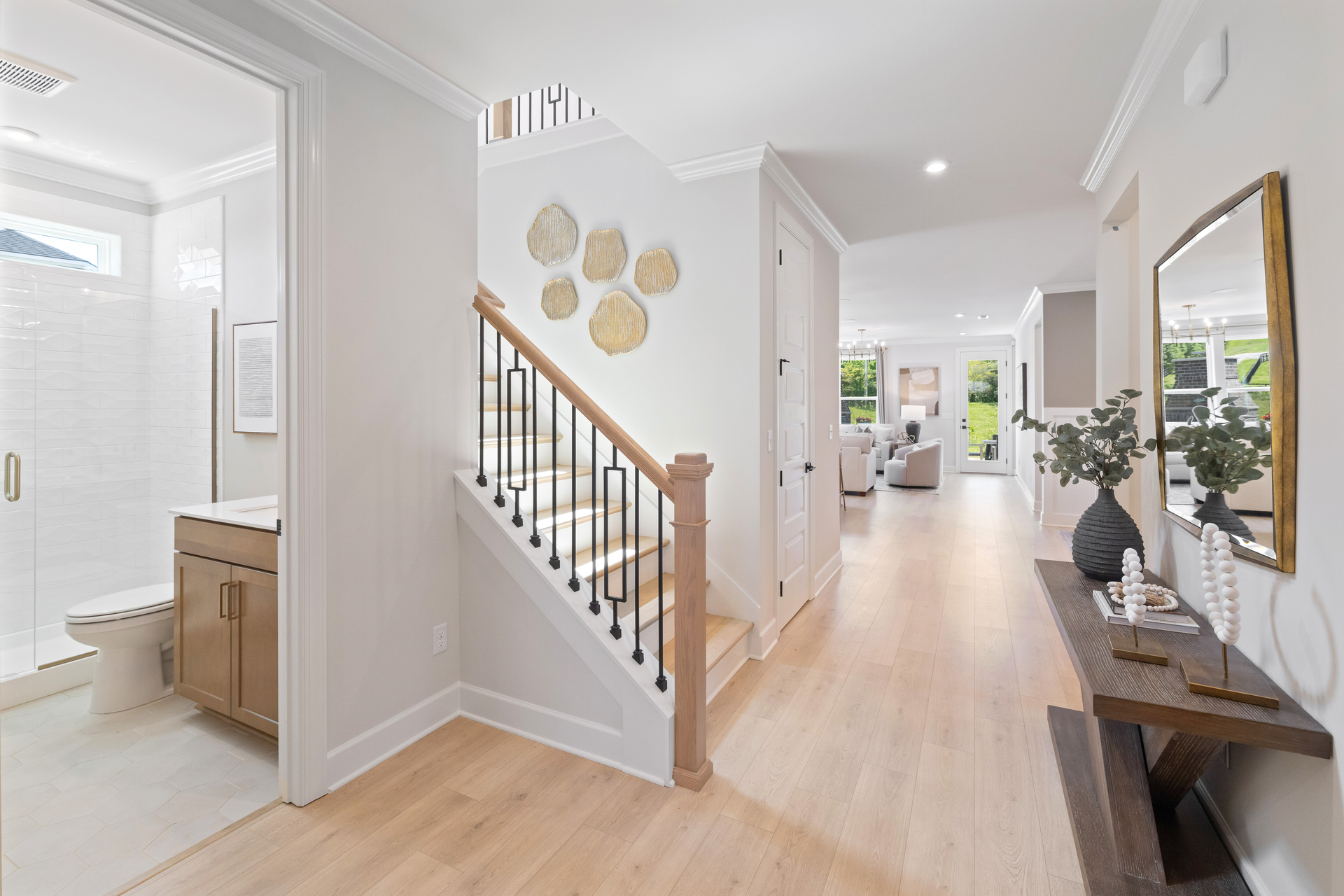 entry with wood floors, entry table, and staircase