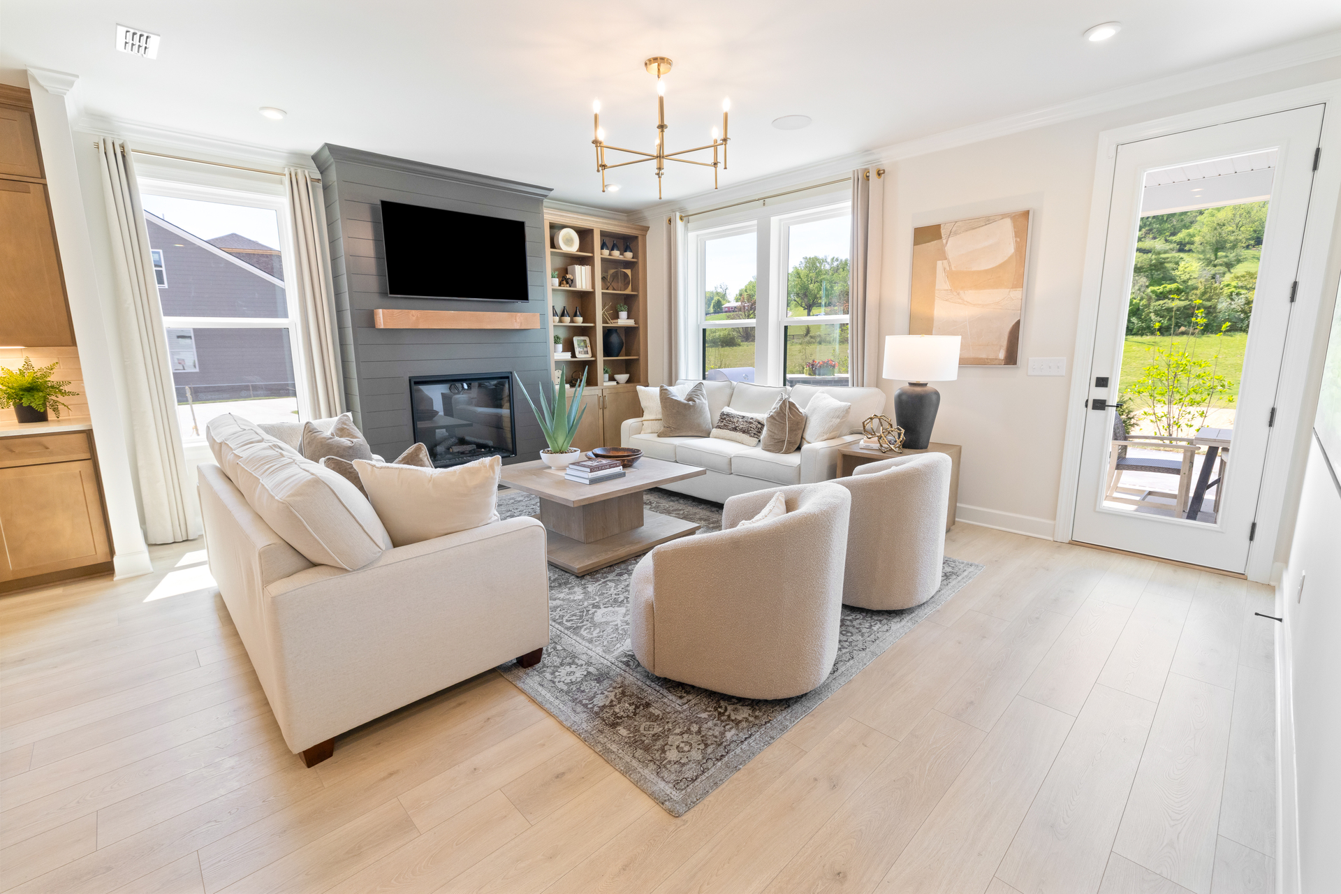 great room with wood floors, fireplace, and large windows