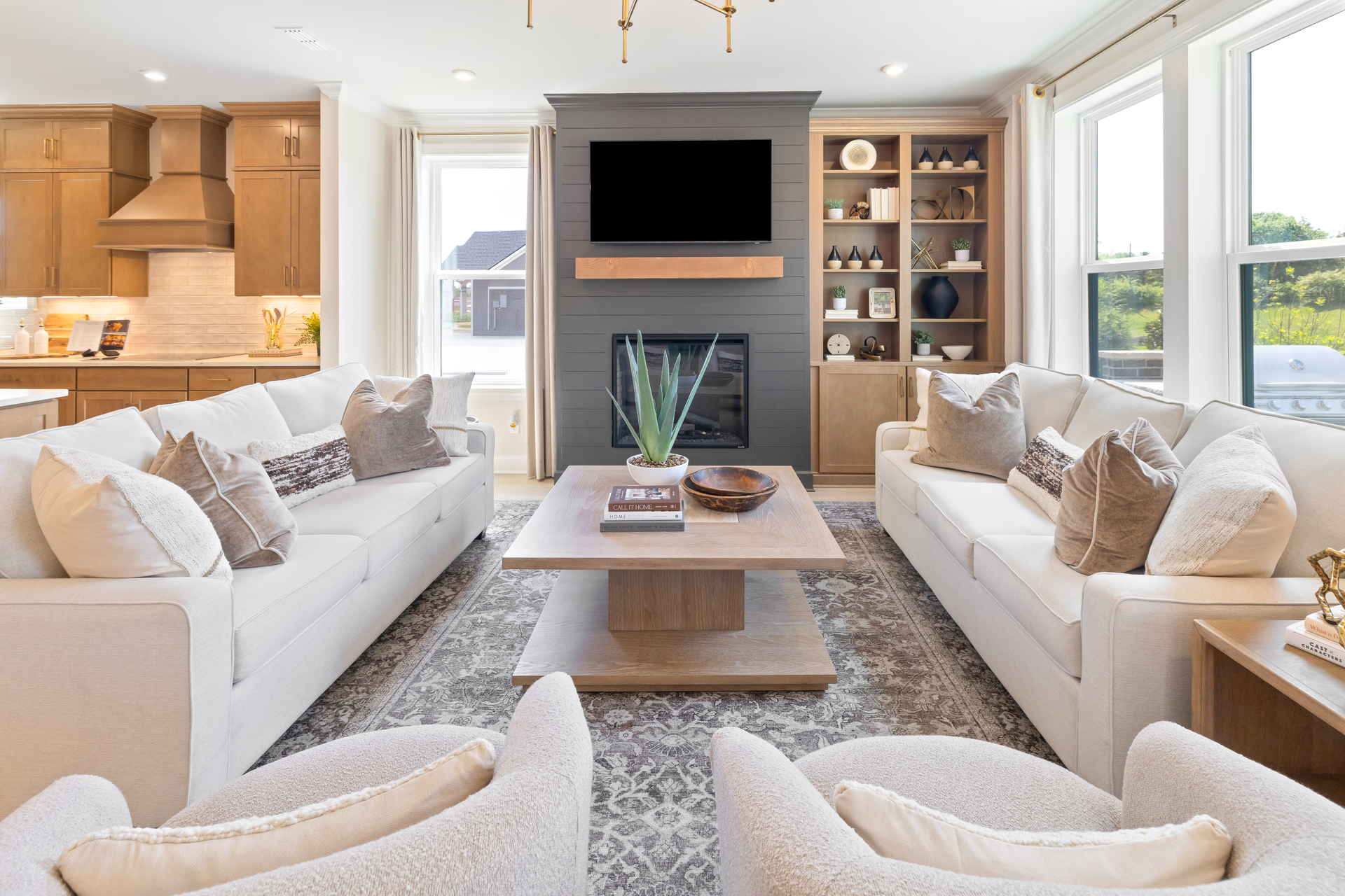 great room with wood floors, fireplace, and large windows