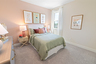 bedroom with carpet and large windows