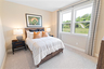 secondary bedroom with carpet and large windows