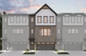 front of 3-story townhome building with brick