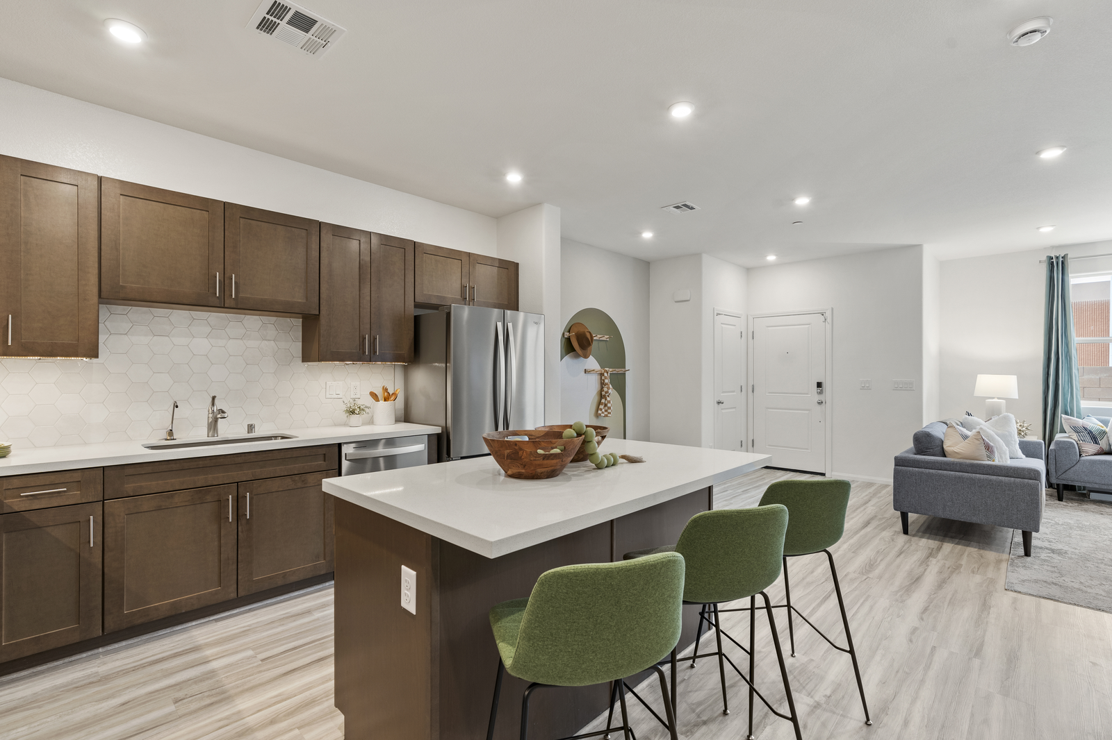 kitchen with white backsplash and green chairs