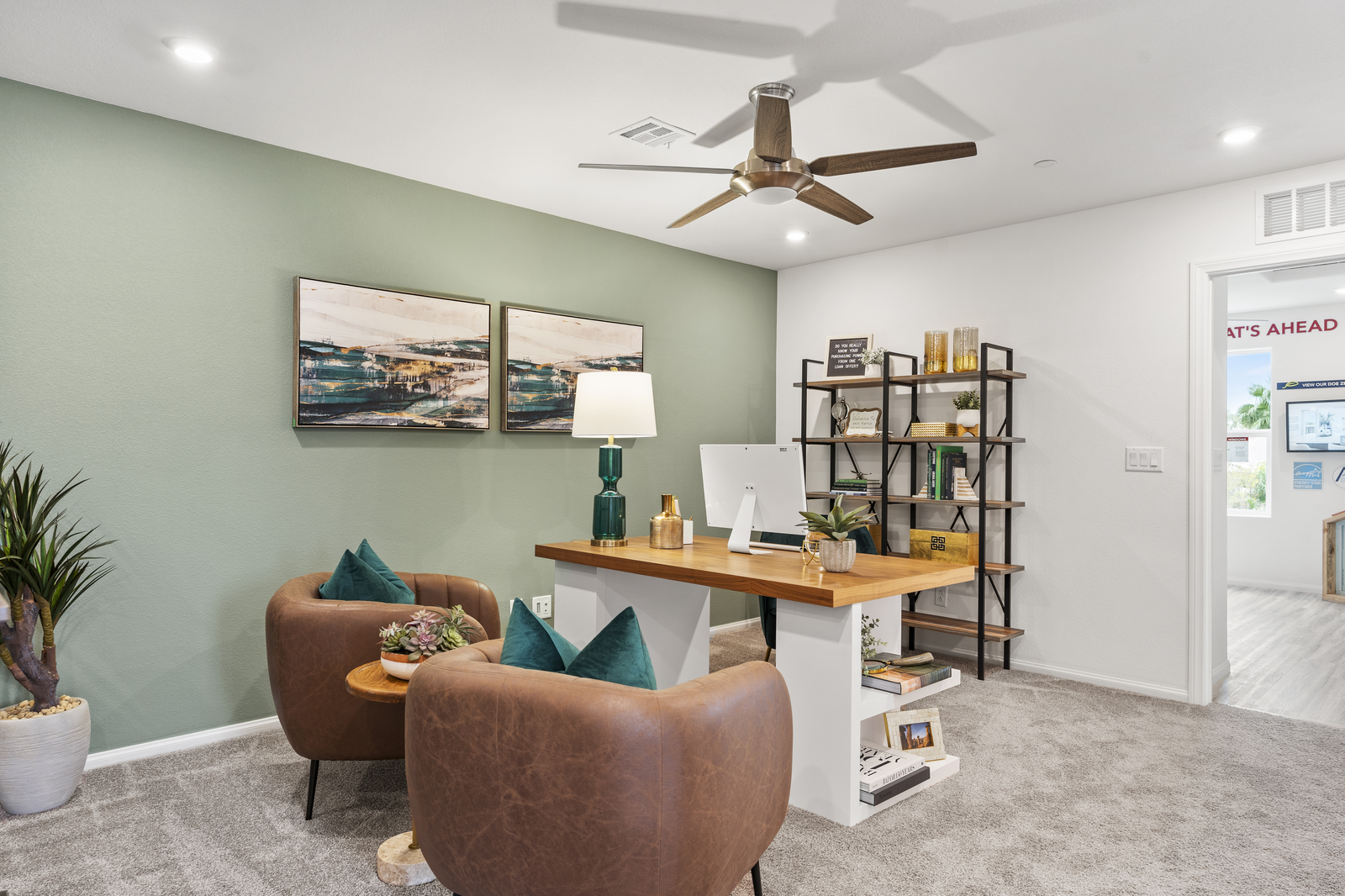 loft with green accent wall and brown chairs